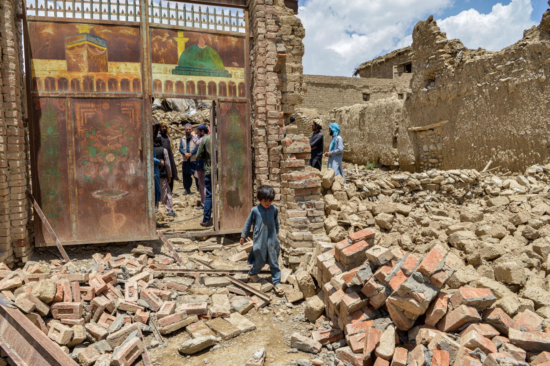 A child walks out from inside a gate of a house damaged by an earthquake in Bernal district, Paktika province, on June 23. Photo: AFP