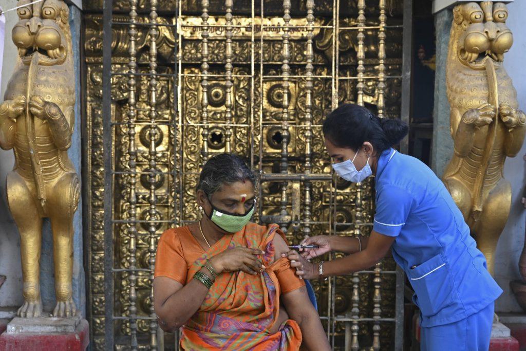 A health worker inoculates a woman with a dose of the Covishield vaccine against Covid-19 during a booster vaccination drive for frontline workers and elderly people in Chennai on Jan 20. Photo: AFP