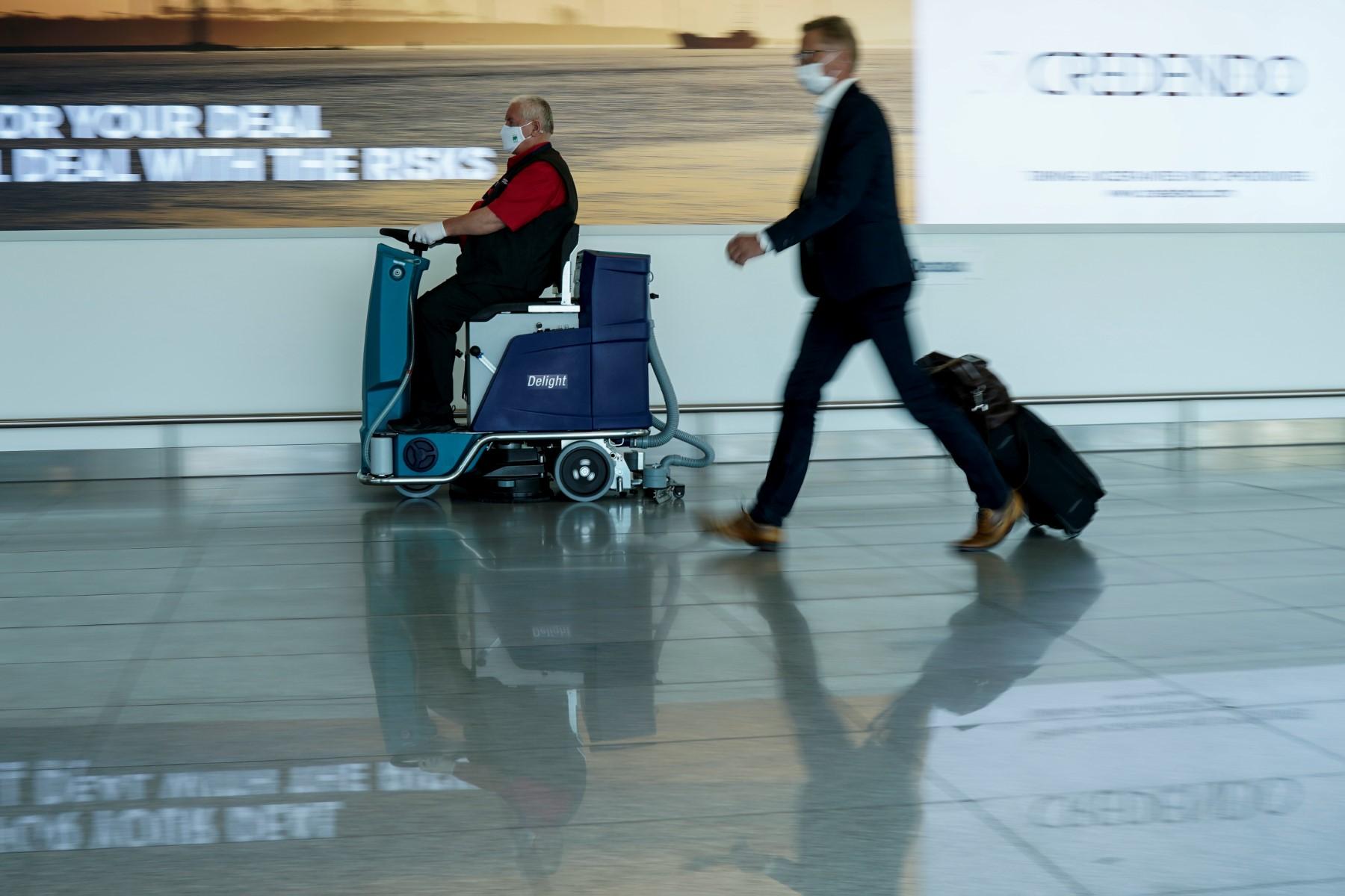 An employee of Brussels airport cleans up the floor at Brussels Airport, in Zaventem, on June 15, 2020. Photo: AFP