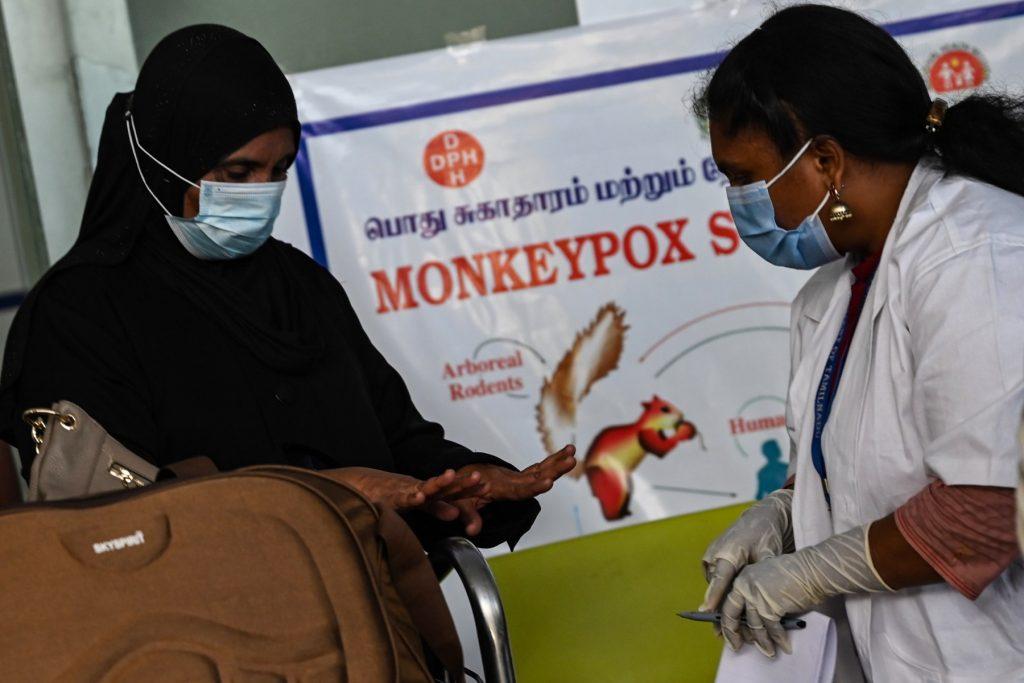 Health workers screen passengers arriving from abroad for Monkeypox symptoms at Anna International Airport terminal in Chennai on June 3. Photo: AFP