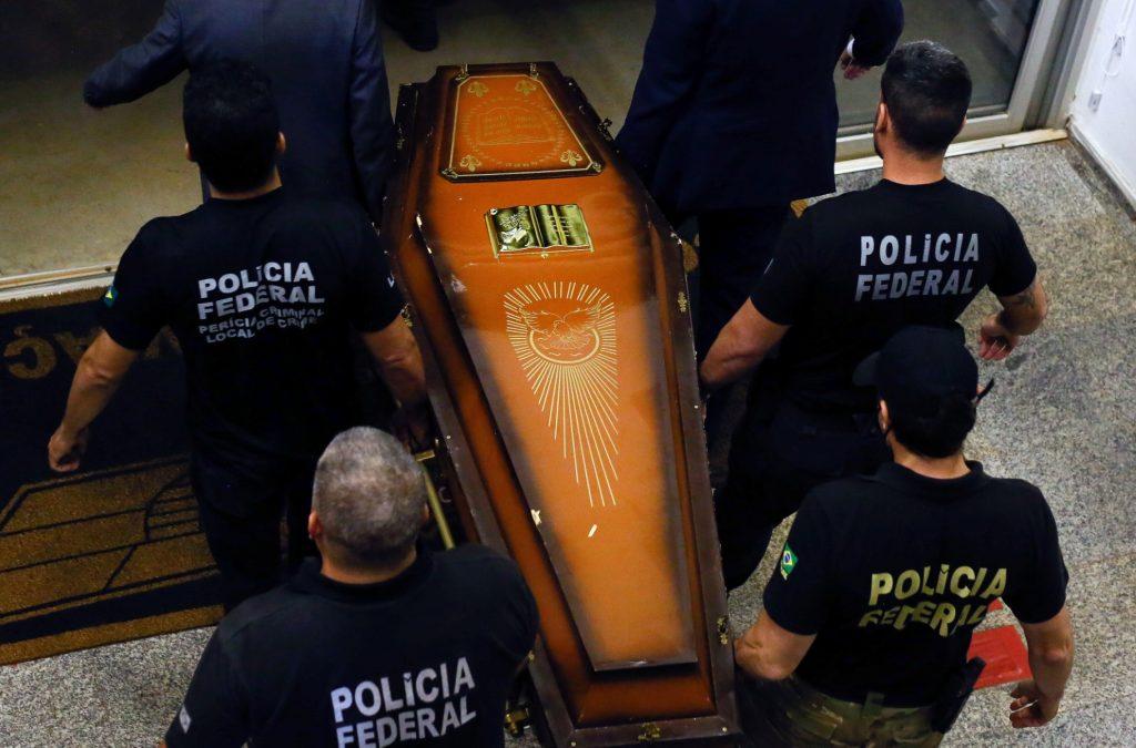 One of the coffins containing human remains found during the search for missing British journalist Dom Phillips and indigenous expert Bruno Pereira in the Amazon forest is carried upon arrival at the federal police hangar in Brasilia on June 16. Photo: AFP