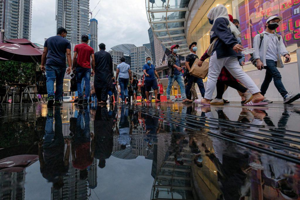 Pedestrians cross a road in the Bukit Bintang shopping district in Kuala Lumpur. A recent survey by independent pollster Merdeka Center has found that just one in four of Malay youth would turn out to vote if the general election is held now. Photo: Bernama