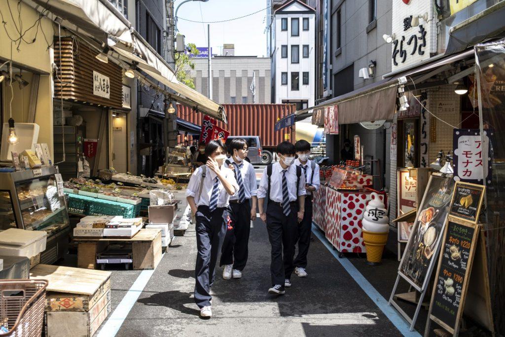 Students walk along a street in Tokyo on April 22. Photo: AFP