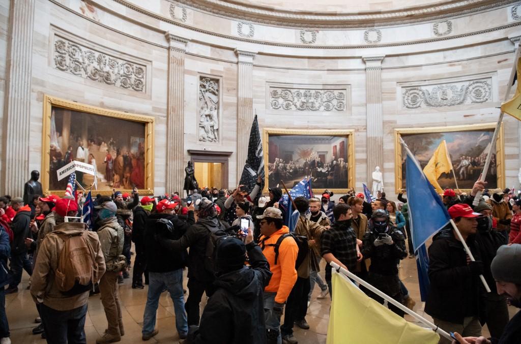 Supporters of former US president Donald Trump walk around in the Rotunda after breaching the US Capitol in Washington, DC, Jan 6. Photo: AFP