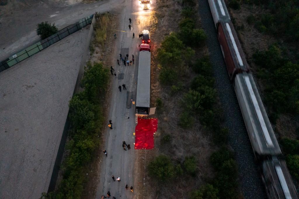 In this aerial view, members of law enforcement investigate a tractor trailer on June 27, in San Antonio, Texas. Photo: AFP