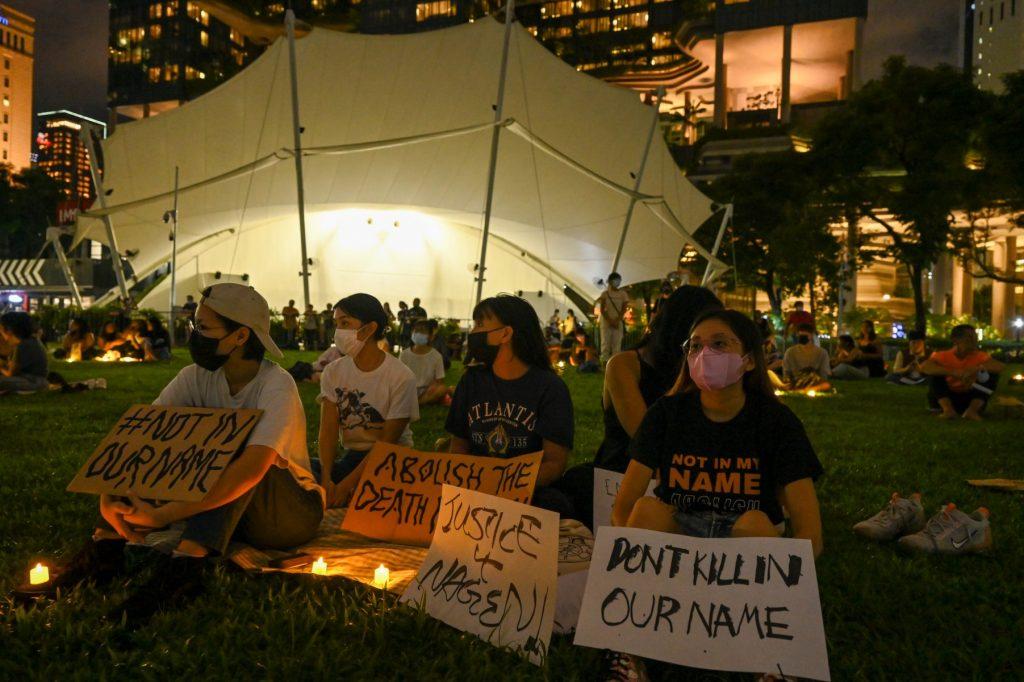 People display placards and LED lights during a vigil for Nagaenthran K Dharmalingam, who was sentenced to death for trafficking heroin into Singapore, at the Speakers Corner in Singapore on April 25, two days before his execution. Photo: AFP