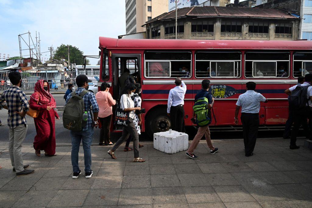 Commuters board a bus in Colombo on March 2, after the country a day before announced nationwide seven-and-a-half hour daily power cuts as its foreign exchange crisis leaves it unable to import oil. Photo: AFP