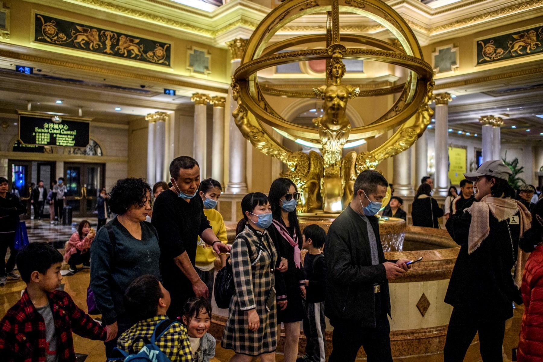 Visitors wear face masks as they walk inside the Venetian casino hotel resort in Macau in this Jan 22 file photo. Photo: AFP