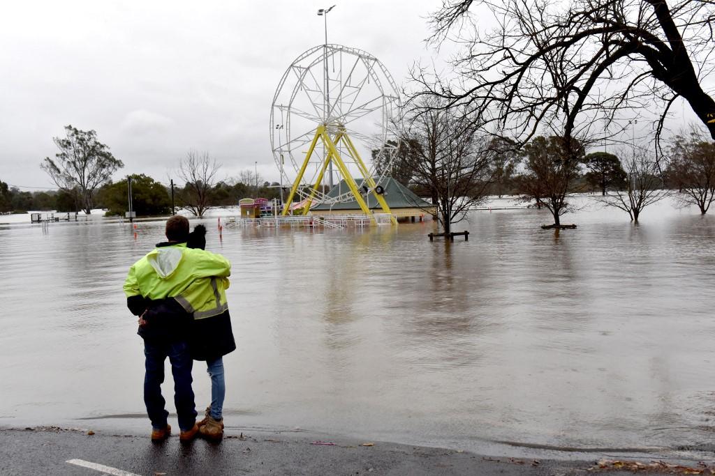 People look at a flooded park due to torrential rain in the Camden suburb of Sydney on July 3. Photo: AFP