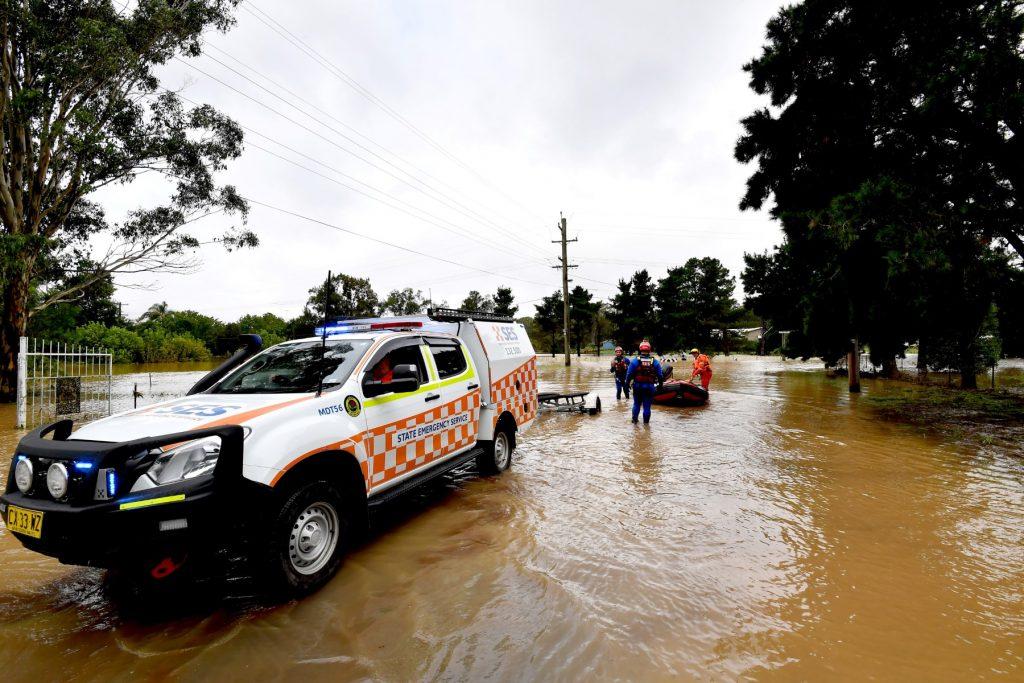 Volunteers of State Emergency Services load their boat during a rescue mission after flood waters inundated a residential area in the western Sydney on March 3. Photo: AFP