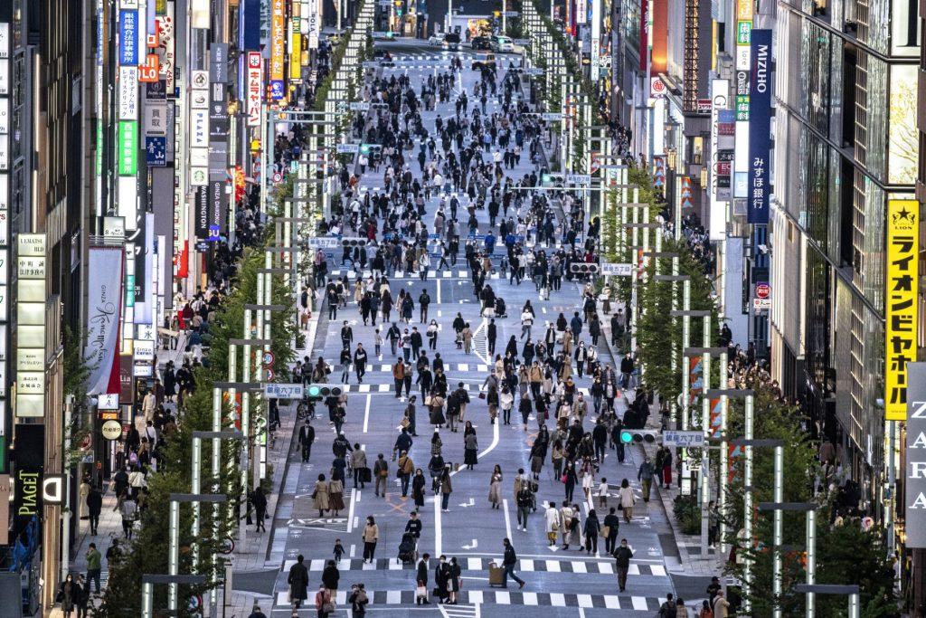 A general view shows people walking on a street in Tokyo's Ginza area at dusk on Nov 7, 2021. Photo: AFP