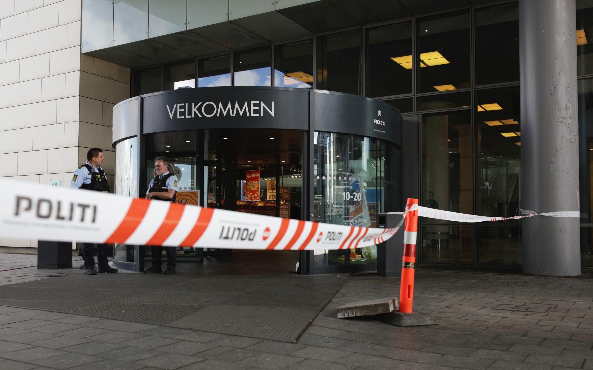 One of the entrances of the Fields shopping mall is cordoned off as police forces stand guard on the site one day after a deadly shooting on July 4, in Copenhagen. Photo: AFP
